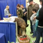 Talking with folks at a trade and leisure show about wild boar in Canada